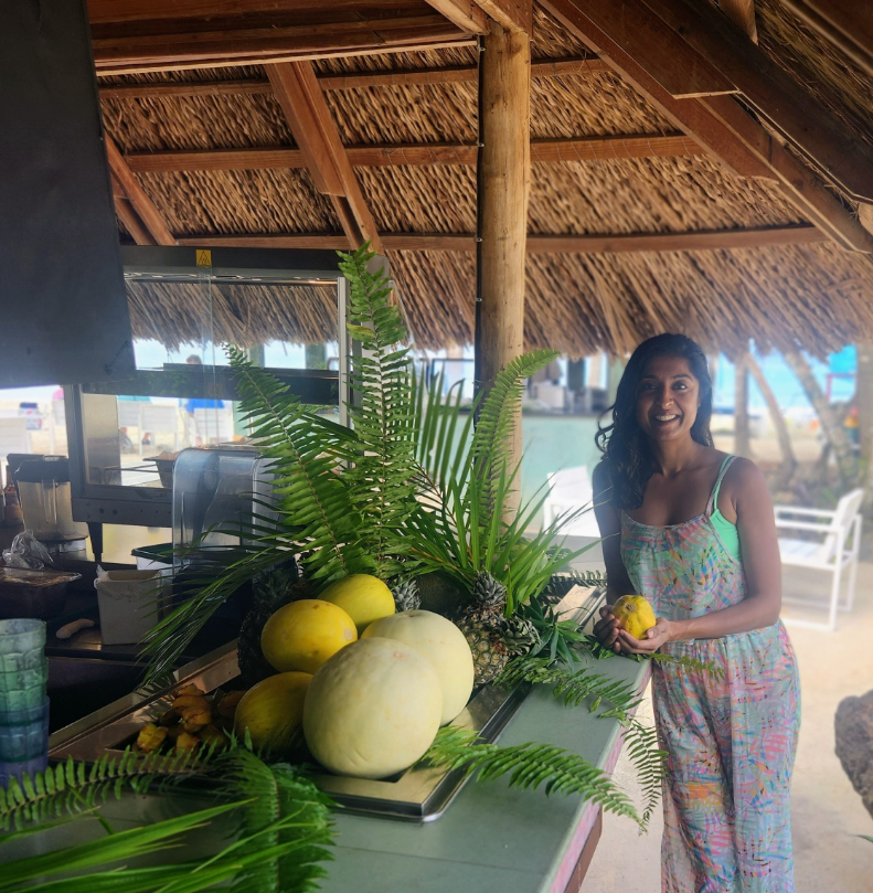 photo of Raman Magay holding fruit at an outdoor fruit bar